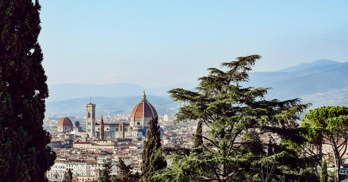 Aerial view of Florence’s Duomo with city rooftops and hills in the background