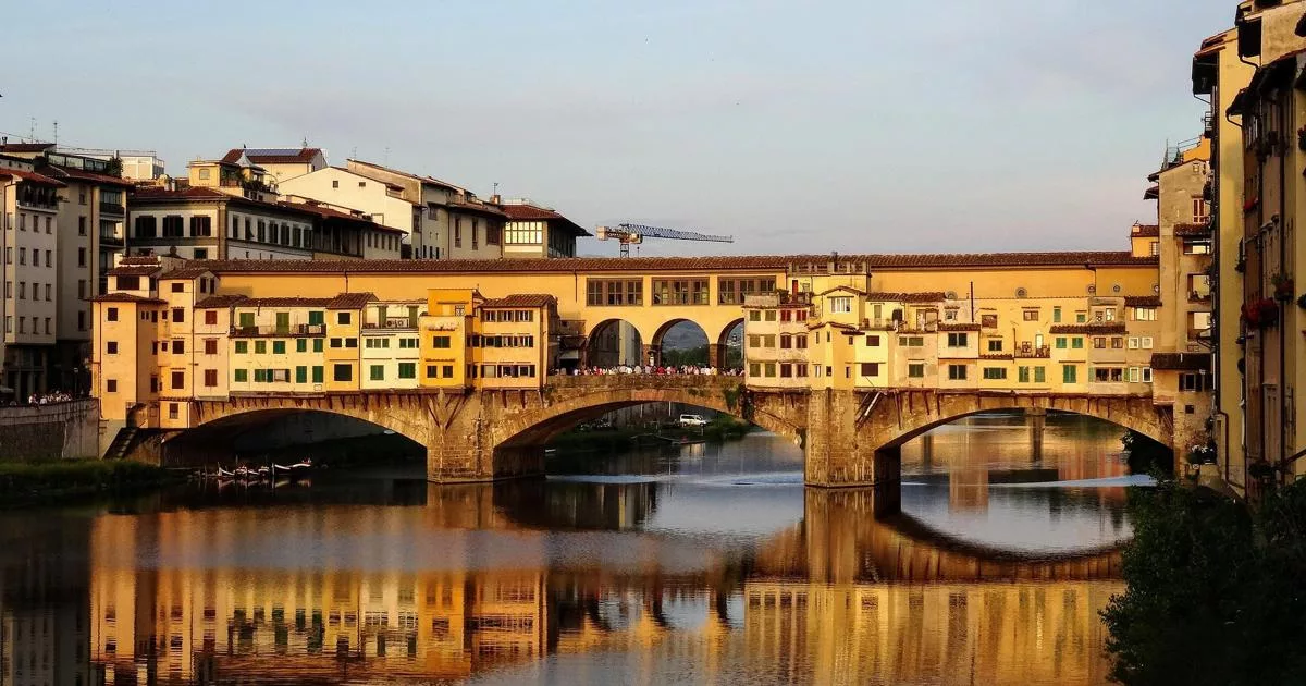 Scenic view of Ponte Vecchio bridge in Florence reflecting on Arno River