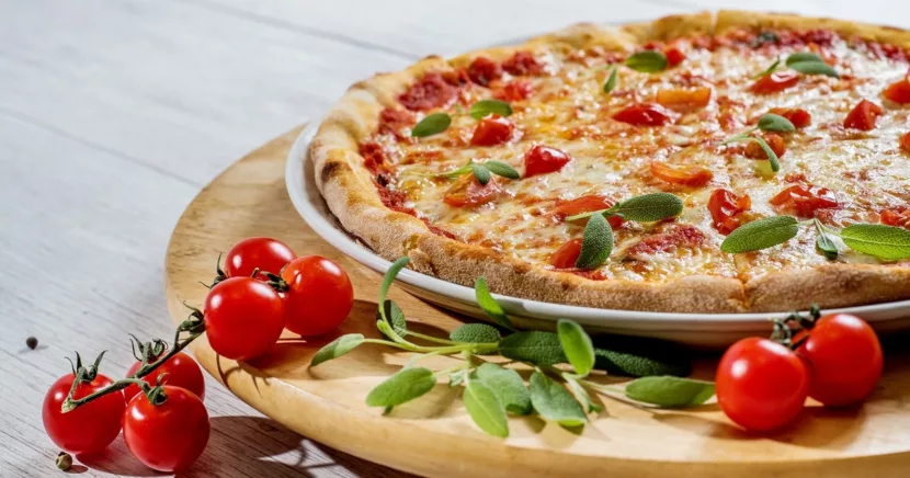 Authentic Italian Pizza with Tomatoes and Herbs on a Wooden Board