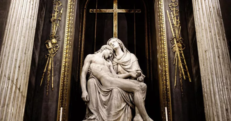 Jesus sculpture in Milan cathedral with golden cross backdrop