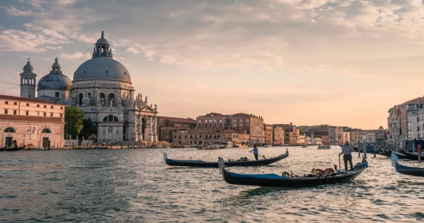 Traditional Gondolas Gliding Through Venices Grand Canal at Sunset