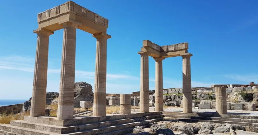 Ancient Stone Columns of the Acropolis of Lindos Under a Bright Blue Sky in Rhodes Greece