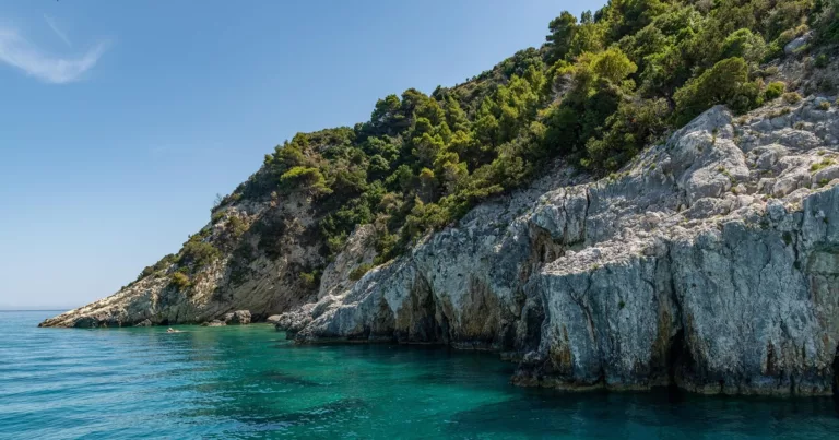 Rocky coastline and clear turquoise sea in Zakynthos Greece under bright sun